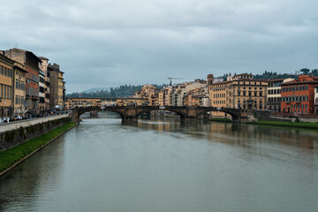 Fototapeta na wymiar Winter rainy Florence. Bridges over the Arno River and Medieval Architecture.