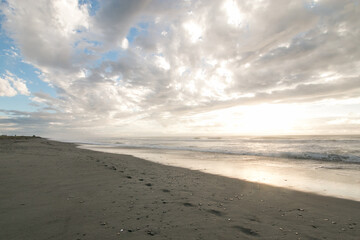 Waves at sunset with footprints - Westcoast of New Zealand