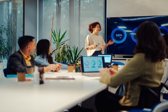 Hispanic latino woman team leader presenting project to its diverse colleagues - Powered by Adobe