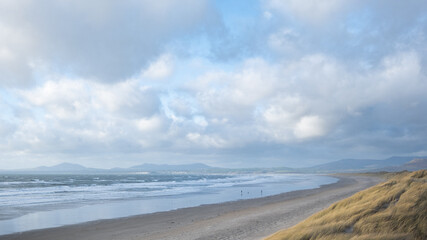 Fototapeta na wymiar The vast expanse of Harlech beach with the mountains of Snowdonia in the distance.