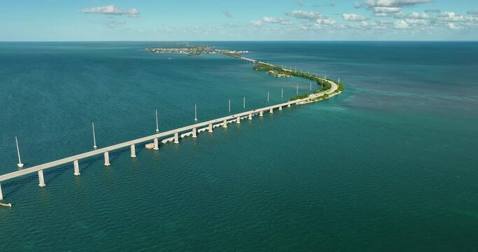 Aerial above Overseas Highway bridge on Florida Keys, road leading towards Miami with turquoise Atlantic Ocean