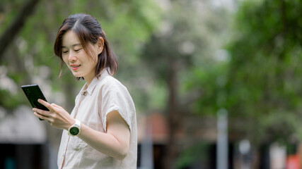 Fototapeta premium Social media and digital online concept, woman using smart phone. The concept of living on vacation and playing social media. Social Distancing ,Working From Home