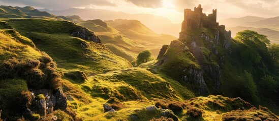 The Fairy Glen's Castle Ewan, a hilltop tourist spot on the Isle of Skye, Scotland, bathed in golden light during sunrise or sunset. - obrazy, fototapety, plakaty
