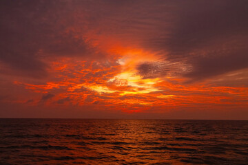 Naklejka na ściany i meble Attractive dramatic red sunset with cloudy sky