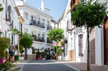 Walking in city center on sunny summer day in Estepona, Spain