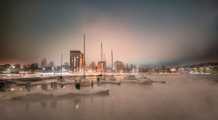 Fototapeta na wymiar Downtown by the harbour in the sea fog
