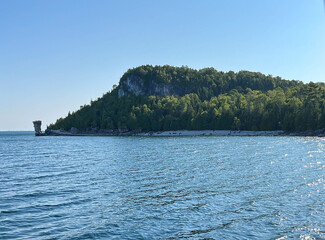 View of a green island from the lake shore