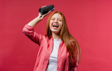 Young teenager listening to music by wireless portable speaker - sound system