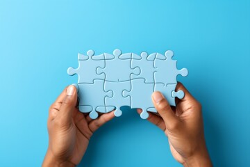 Blue puzzle pieces in hand on blue background,