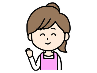 拳を握るエプロン姿の女性