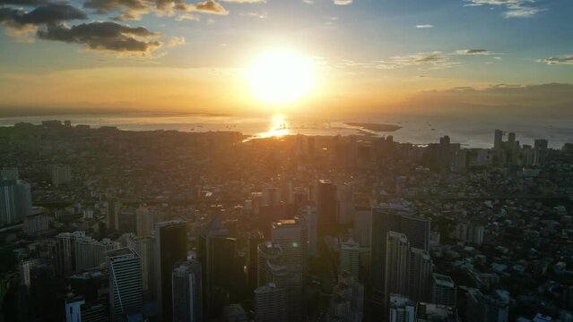 Aerial view of skyscrapers buildings in Makati business district and Manila city at sunset, capital of Philippines, panorama 4k