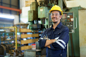 Smart and good looking senior factory or mechanical engineer standing in the factory portrait.