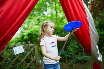 Preschooler girl practicing spinning circus skills © Ekaterina Pokrovsky