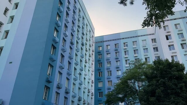 Clinic building exterior among the trees. Bottom up view of a hospital  windows. Wide low angle shot