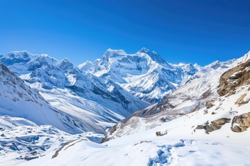 Fototapeta na wymiar Mountain landscape with snow peaks and clear blue sky