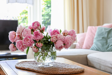 Beautiful pink peonies in vase on table at home, space for text. Interior design - obrazy, fototapety, plakaty