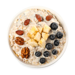 Tasty boiled oatmeal with blueberries, banana and nuts in bowl isolated on white, top view