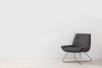 Comfortable armchair near white wall indoors. Space for text