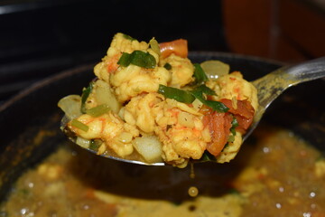 Curried shrimp seasoned with green herbs or seasoning including culantro, chive, celery, garlic,...