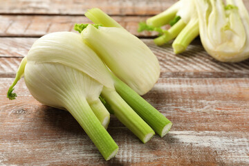 Fresh raw fennel bulbs on wooden table, closeup