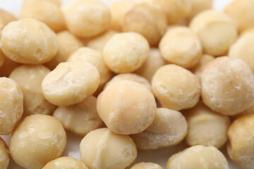 Tasty peeled Macadamia nuts as background, closeup