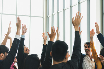 Successful business people raised their hands up for voting showing their approval volunteering in the office seminar with happiness. Smile managers put their hands up in the air. Intellectual. - obrazy, fototapety, plakaty