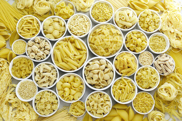 Mix of pasta shapes varieties: penne and fusilli, farfalle and macaroni, rigatoni and rotini,...