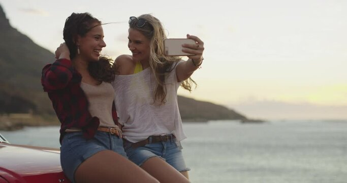 Adventure, selfie and girl friends on a road trip with a car for bonding weekend, holiday or vacation. Happy, smile and young women taking a picture by the ocean or sea in Australia together.