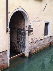 old door in canal, Venice, Italy