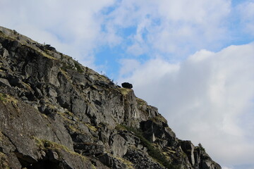 A boulder hanging on the slope of a mountain