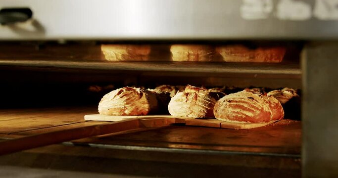 Taking freshly baked bread out of the oven 4K, healthy home-made breakfasts, bakery and pastries, production of healthy food, traditional regional specialties.