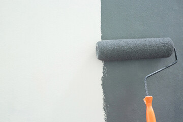 Roller Brush Painting, Worker painting on surface wall  Painting apartment, renovating with grey color  paint. Leave empty copy space white to write descriptive text beside.