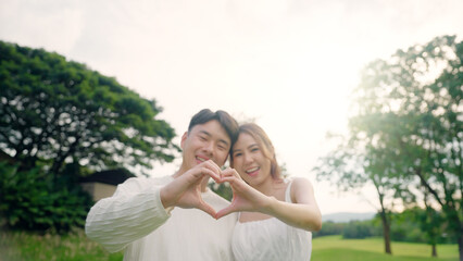 Young asia people happy lover flirt fall in love care trust hand sign tender symbol. Just married...