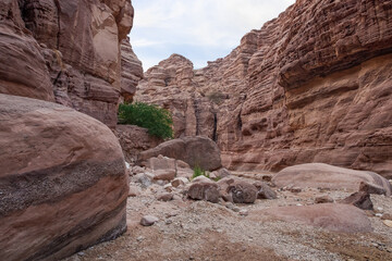 High  rocks with beautiful natural patterns at end of hiking trail in the Wadi Numeira gorge in Jordan