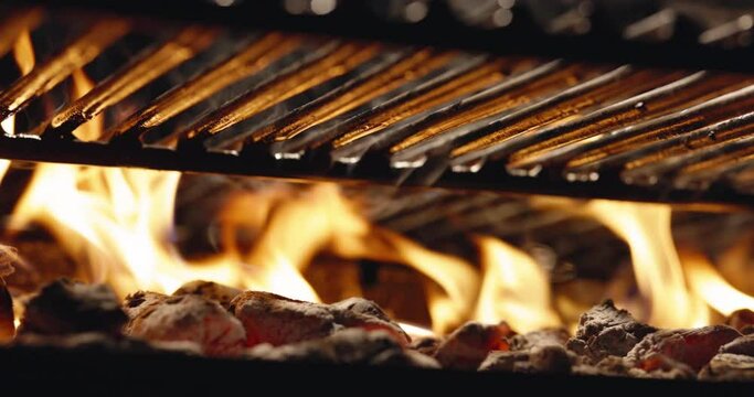 Flame provides ideal cooking temperature. Close-up of burning coals in grill. BBQ grill with blazing flames. Coals are ready for cooking. Beautiful sight for any grill master. Slow motion cinematic AD