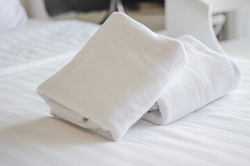 Clean towels on bed at hotel room and copy space.