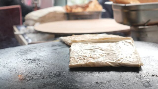 cooking turkish food. pita bread is cooked on the street. 