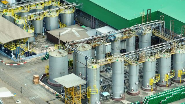 The lubricant plant, a secret elixir factory for machines, concocts silky potions that make gears dance and engines purr. A symphony of science and art, it fuels our mechanical world. Drone view.
