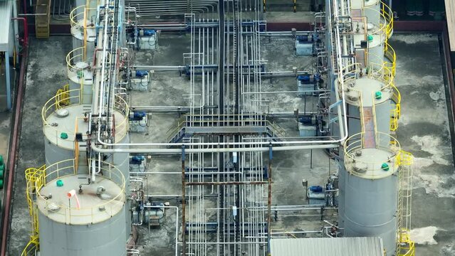 A lubricant plant is a facility that produces various types of lubricants, essential for machinery and vehicles. It blends oils and additives to create high-quality products. Aerial footage.
