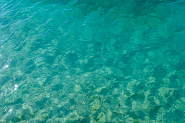 Clean transparent sea water, lake bottom and sand. Beautiful blue, turquoise transparent surface