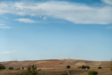 Obraz premium Beautiful summer mountain landscape. Wheat fields and mountains. Kyrgyzstan. Natural background