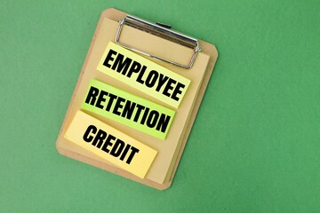 colored paper with the word Employee Retention Credit. the concept of employee salary retention