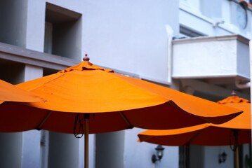 Orange umbrella at an outdoor cafe at summer