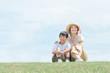 青空の見える公園で遊ぶ家族・ファミリー・親子
