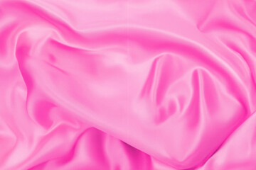 Plastic pink satin fabric texture soft blur background