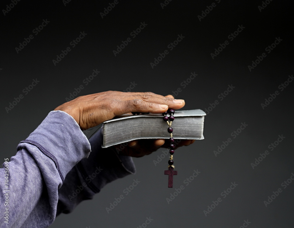 Wall mural praying to god for forgiveness Caribbean man praying with grey black background with people stock image stock photo photo