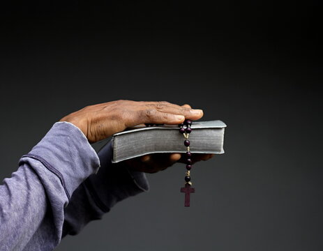 praying to god for forgiveness Caribbean man praying with grey black background with people stock image stock photo photo