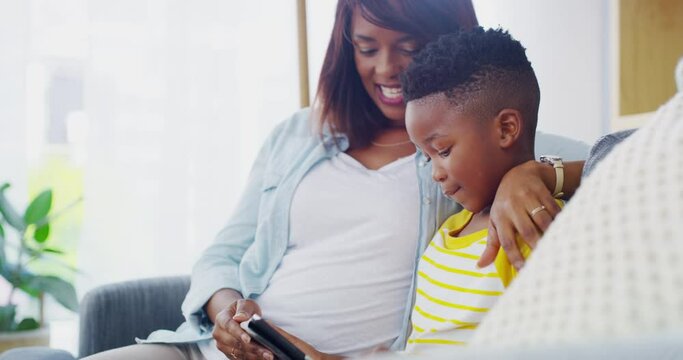 Child, mother and tablet on sofa in home to watch movies, play video games and educational multimedia. Happy mom, boy kid and black family streaming cartoon, digital ebook and elearning app in lounge