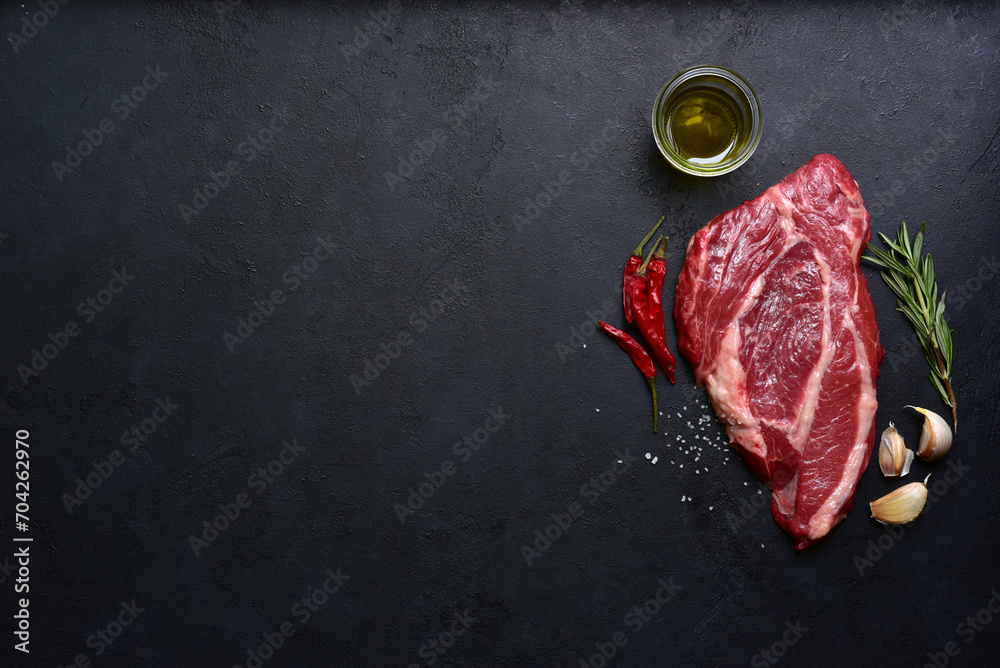 Poster Raw organic marbled beef steak with ingredients for cooking. Top view with copy space.