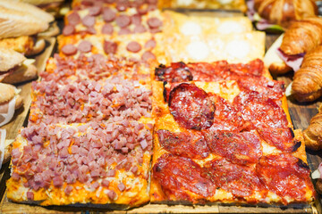 Savory pizza with various toppings on display.